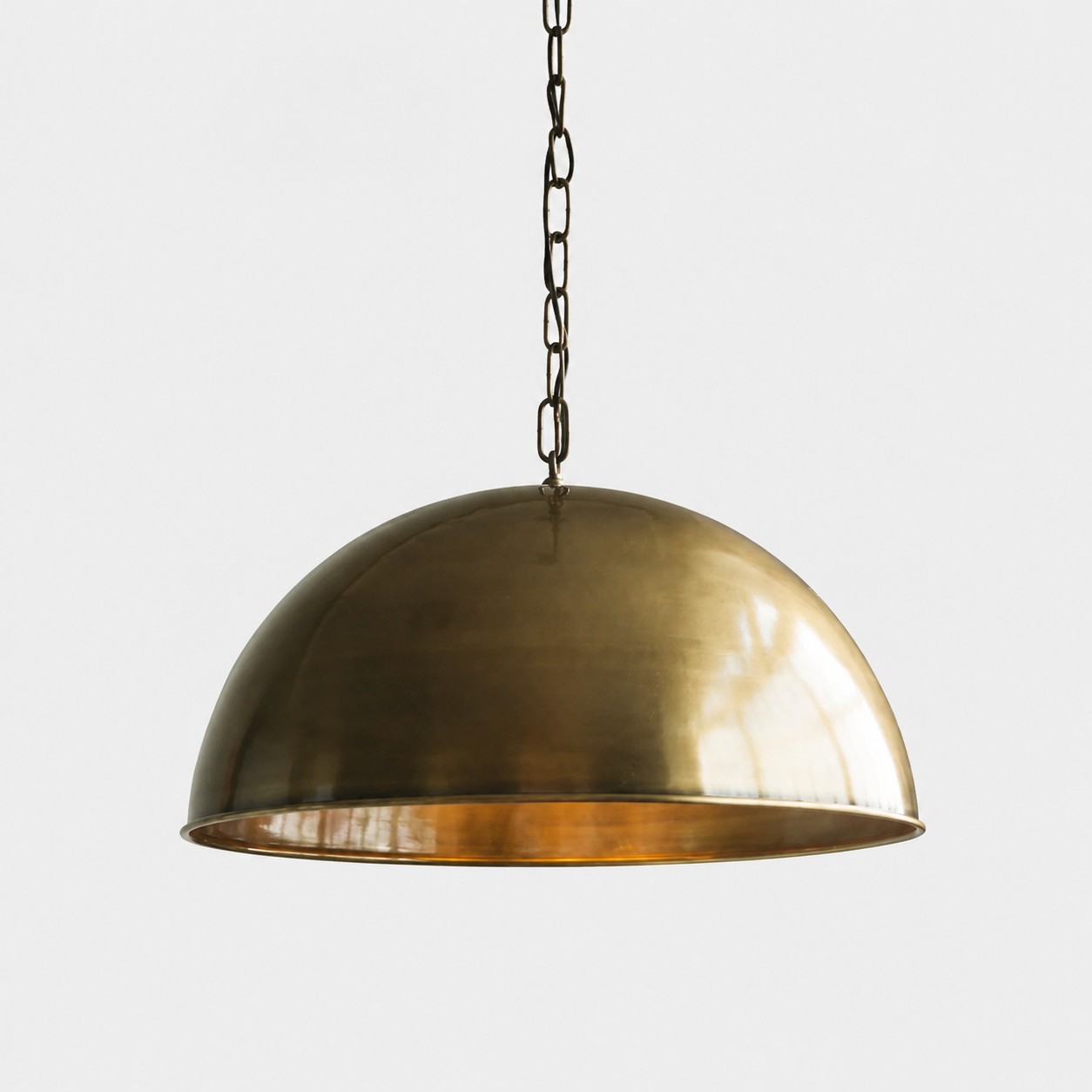 Antique brass dome pendant light on a clean white background