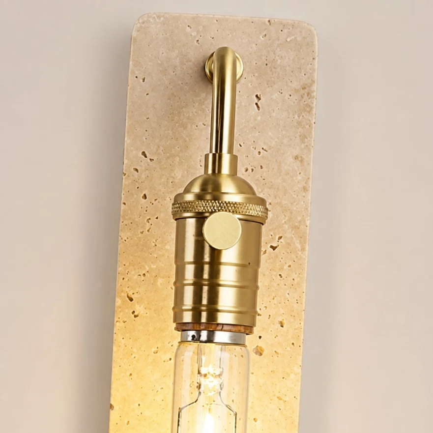 Gold socket switch and travertine face detail