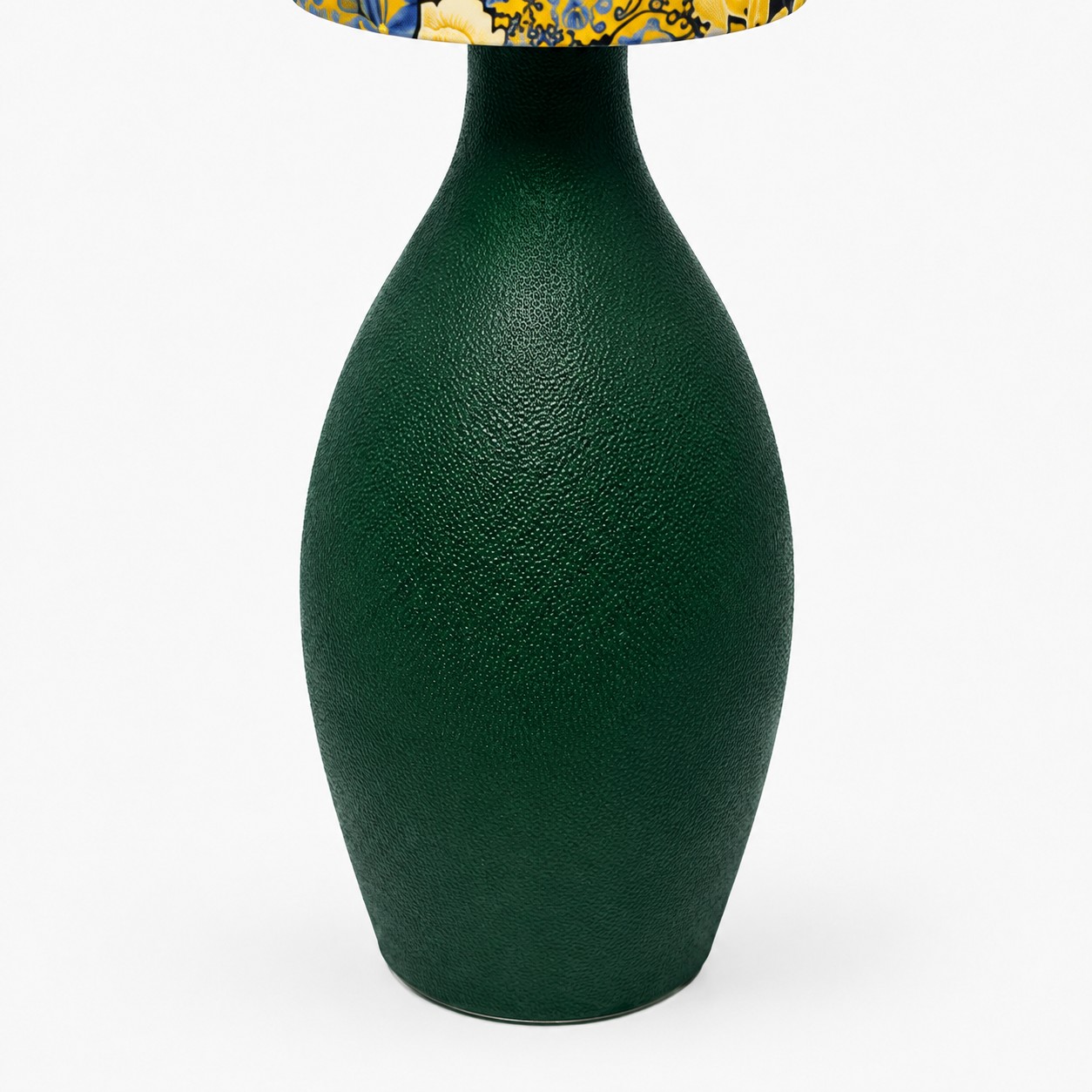 Close view of deep green sculpted lamp base